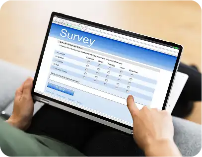 Surveys & Research - Person interacting with survey form on tablet